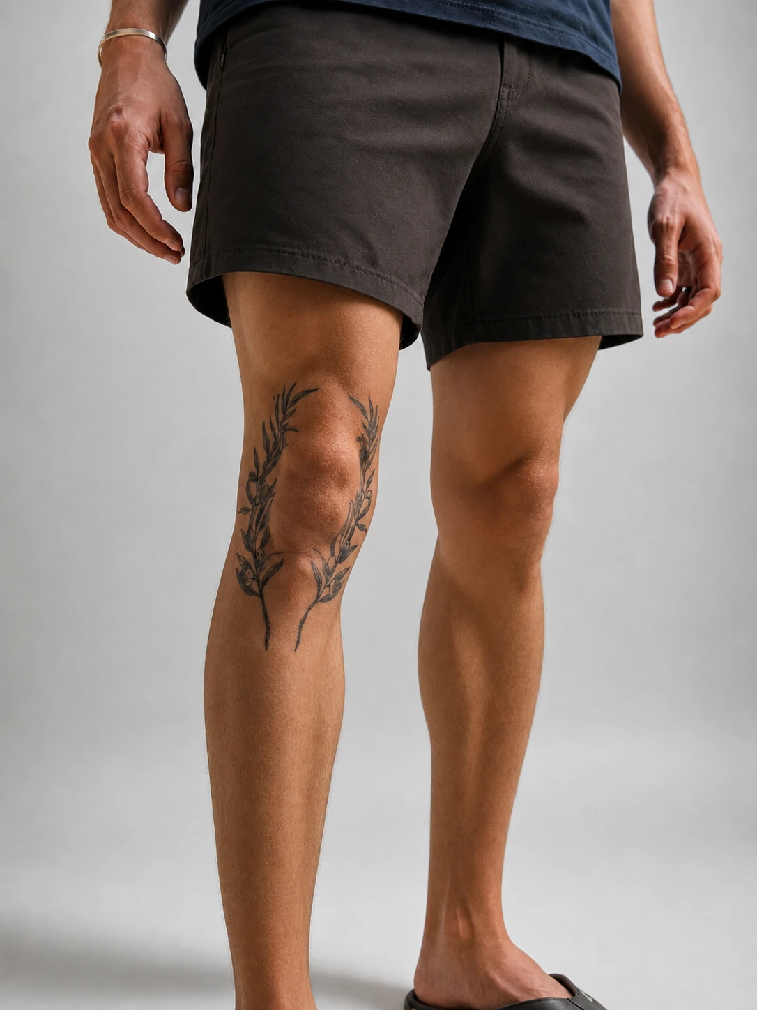 A healed botanical tattoo running over the knee and down the shin
