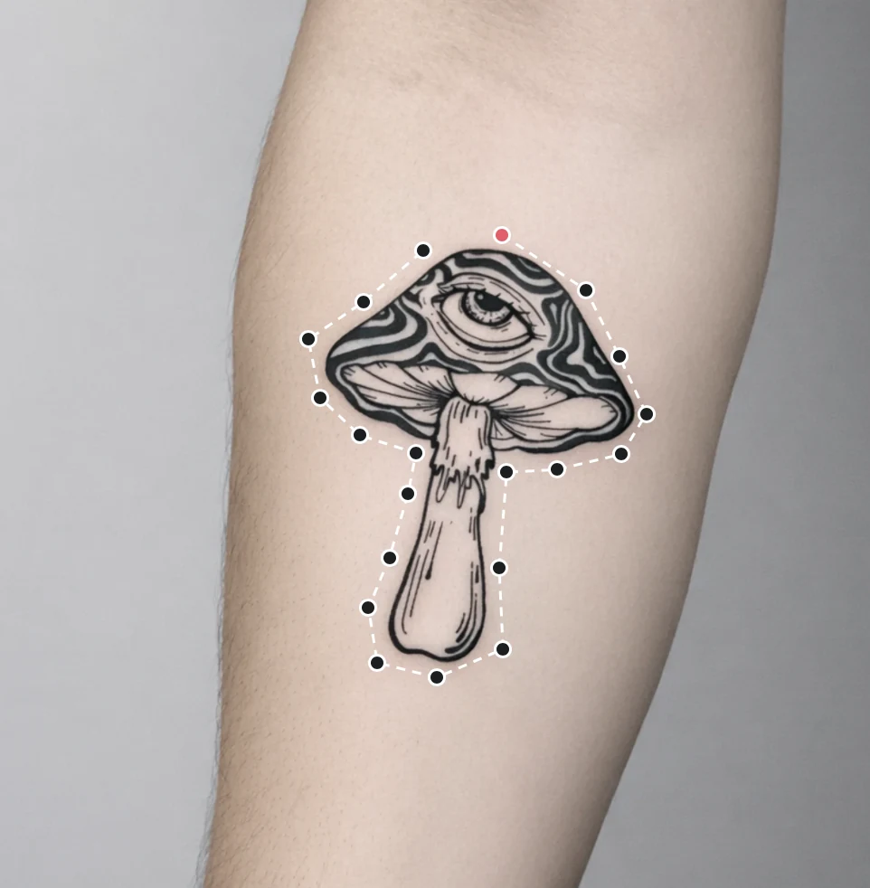 A closed outline of points and a dashed line traced around a single mushroom tattoo on a forearm.